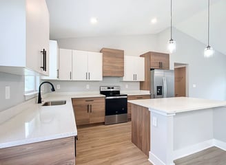 Transitional kitchen remodel with island seating, wood flooring, and seamless integration of modern