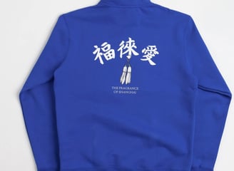 Nike SB x Fly Streetwear 1/2 zip fleece in royal blue with white accents, featuring co-branded chest logo and 'The Fragrance