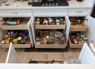 Kitchen roll out shelves that maximize available storage space.