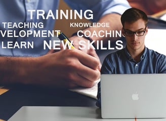 Man in front of a laptop and various training words in the background