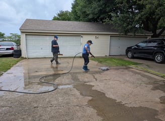 Team surface cleaning a residential driveway in Denton Texas.
