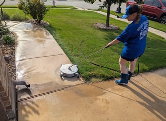 Cleaning a side walk in Ponder Texas.