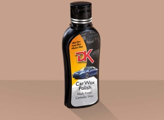 1. A bottle of carnauba wax polish on a brown background, enhancing car paint with high gloss and scratch removal properties.