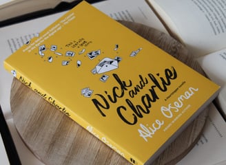 a book with a yellow book cover and a book on a wooden table