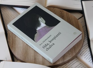 a book with a cat sitting on a wooden table