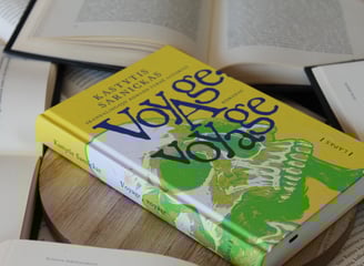 a book with a yellow book cover and a book on a table