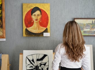 Mulher admirando uma pintura abstrata em uma galeria de arte moderna.