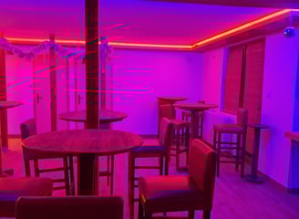 a bar with a purple light and a purple light