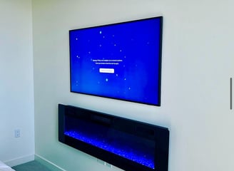 TV mounted with a electric fire place.