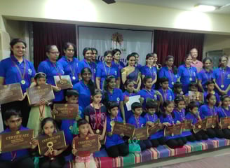 a group of people standing around a group of medals