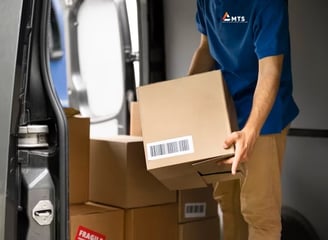 MTS driver loading boxes carefully ready for next day delivery