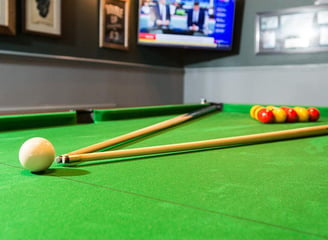 a pool table with pool cues