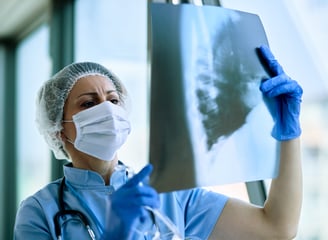 Nurse looking at the x-ray report