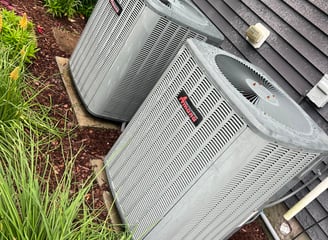 two hvac units sitting outside