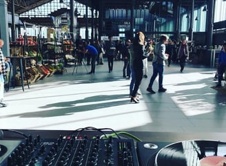 a dj - zoller mixing music in a large room