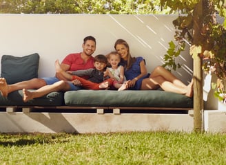 a family sitting on a couch in a back garden, ID 57808384 © Ammentorp | Dreamstime.com