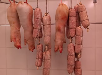a bunch of meat hanging from a ceiling
