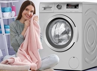 a woman sitting on a chair in front of a washing machine