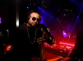 a dj Rico Sanchez in a dj booth at a nightclub