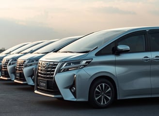 Row of Toyota Alphard luxury vans ready for airport transfers and VIP chauffeur service in Thailand