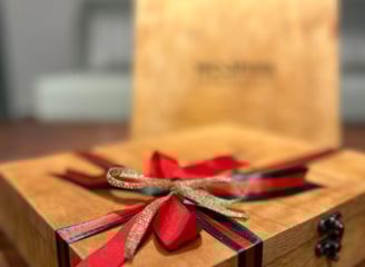 a wooden box with a red ribbon tied to it