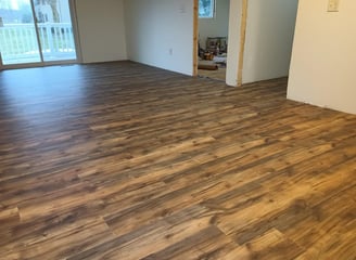 New vinyl laminate flooring was spread throughout this house in Goshen, IN, while being remodeled.