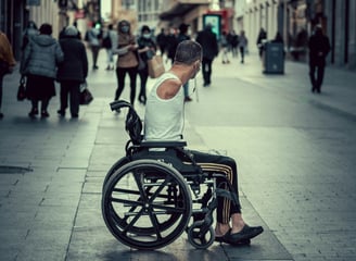 Mann mit Rollstuhl steht in einer Stadt