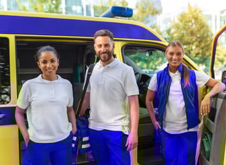a group of people standing in front of a medical transportation