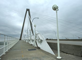 a bridge with a white bridge and a street light