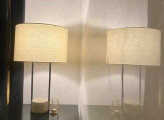 two lamps on a table with a mirror and a mirror