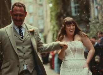 a man and woman walking down a street
