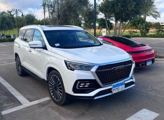 a white suv parked in a parking lot