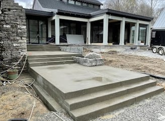 a house with a concrete patio and stairs