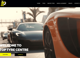 a car with a large screen displaying a photo Top Tyre Centre Website