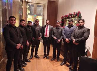 a group of men in suits and ties standing in a room