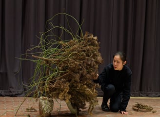 Hedy Leung performing Ikebana with dried green materials at The Wash Houses, London