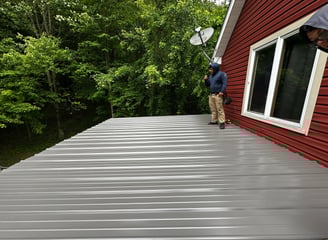 roofer standing on top of finished metal roof.