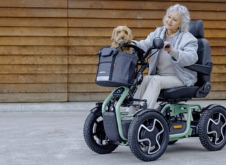 A Scoozy S800 being driven my a happy lady with a happy dog in the basket