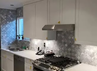 a kitchen with white kitchen cabinets Euro-style