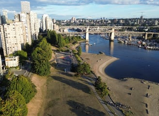 a cityscape of a river with a bridge in the background