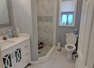 a main bathroom with a toilet and a shower