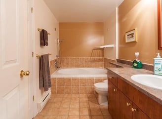 a bathroom with a tub and a toilet