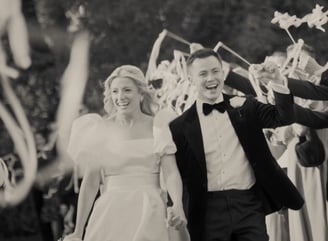 a bride and groom walking down a path with confettirs