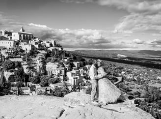 Editorial engagement photo – couple with stunning view of Gourdon village in the background