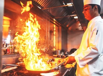 Culinary arts student preparing gourmet dish in professional kitchen