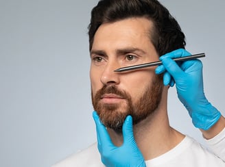 Wireframe nose on man's face, gloved hand touches, symbolizing surgical planning.