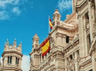 a large building with a spanish flag on top of it