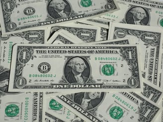 a pile of money bills and dollars bills