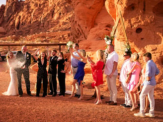 a group of people standing around a man in a suit and tie