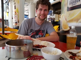 Steven enjoys some local cuisine in Chinatown of Singapore